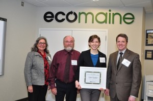 Tyler Kidder (pictured middle) holding the award for eco-Excellence from ecomaine for the Tiny Trash Initiative.